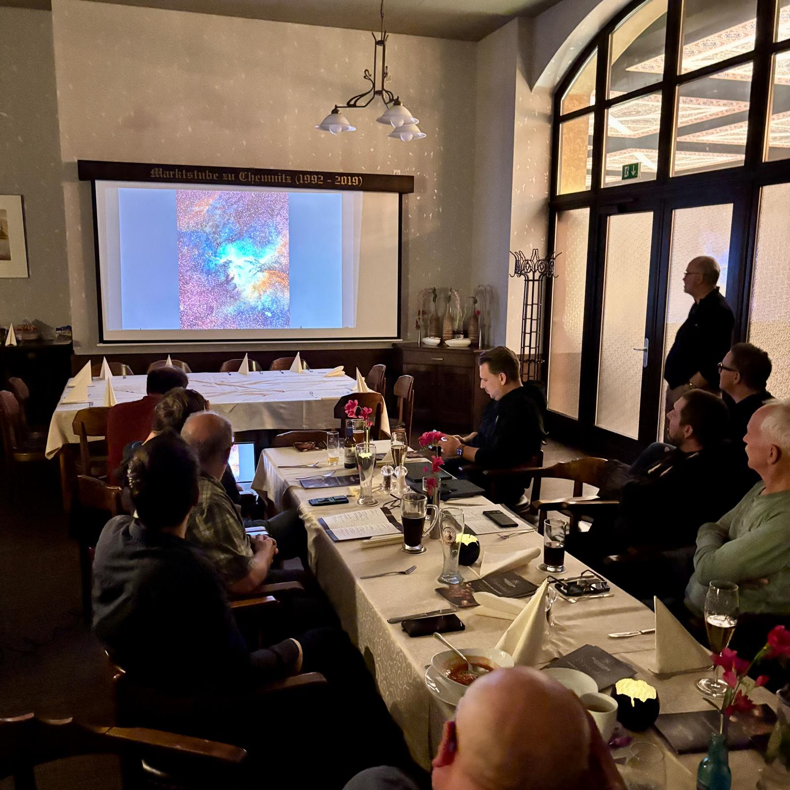 Monthly meetup: members watching an image-processing talk on a projector