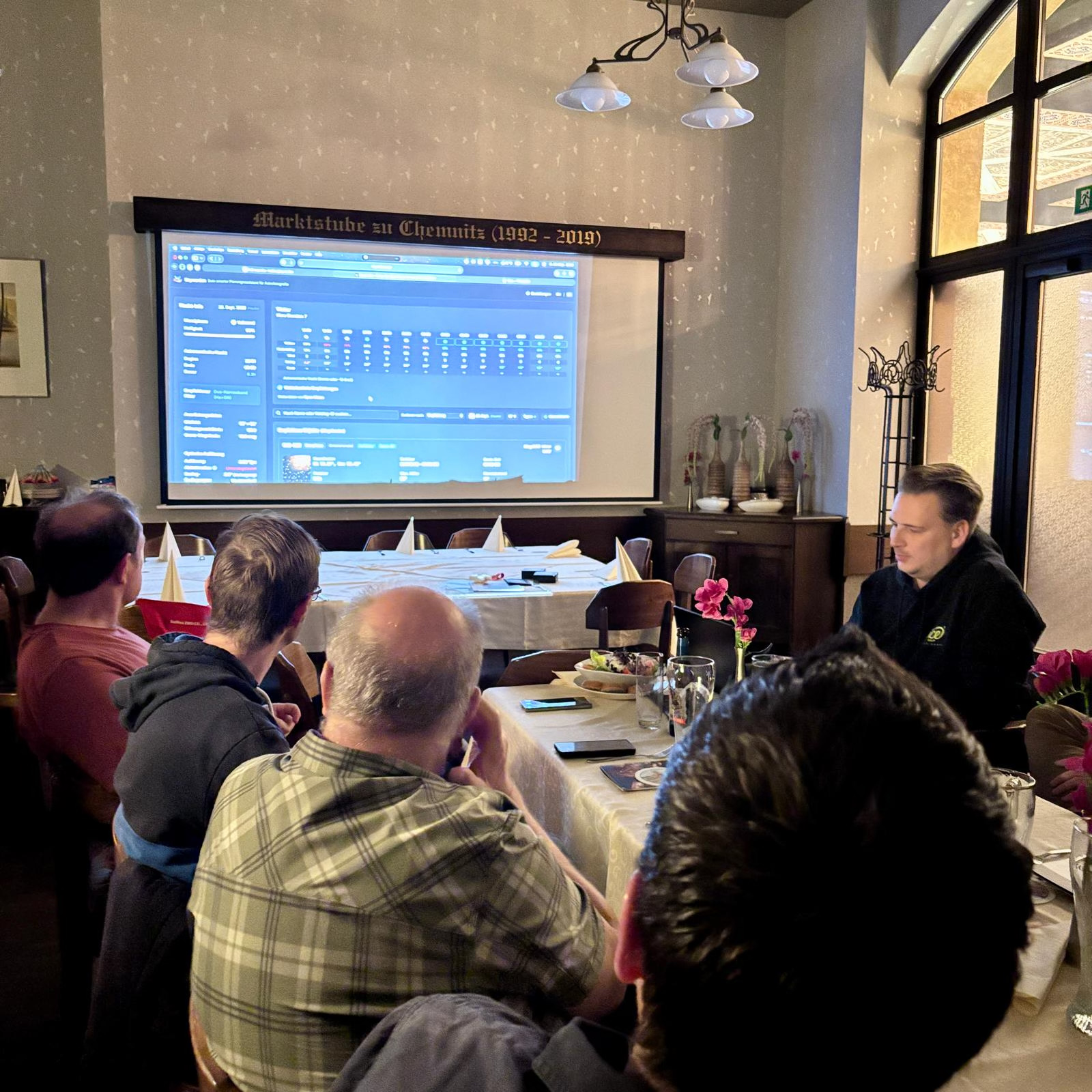 Members at the monthly meetup looking at a presentation